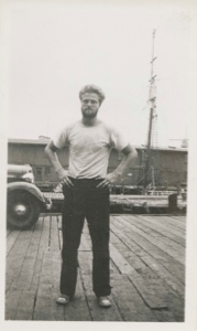 Image of Man on dock; Thebaud tied beyond